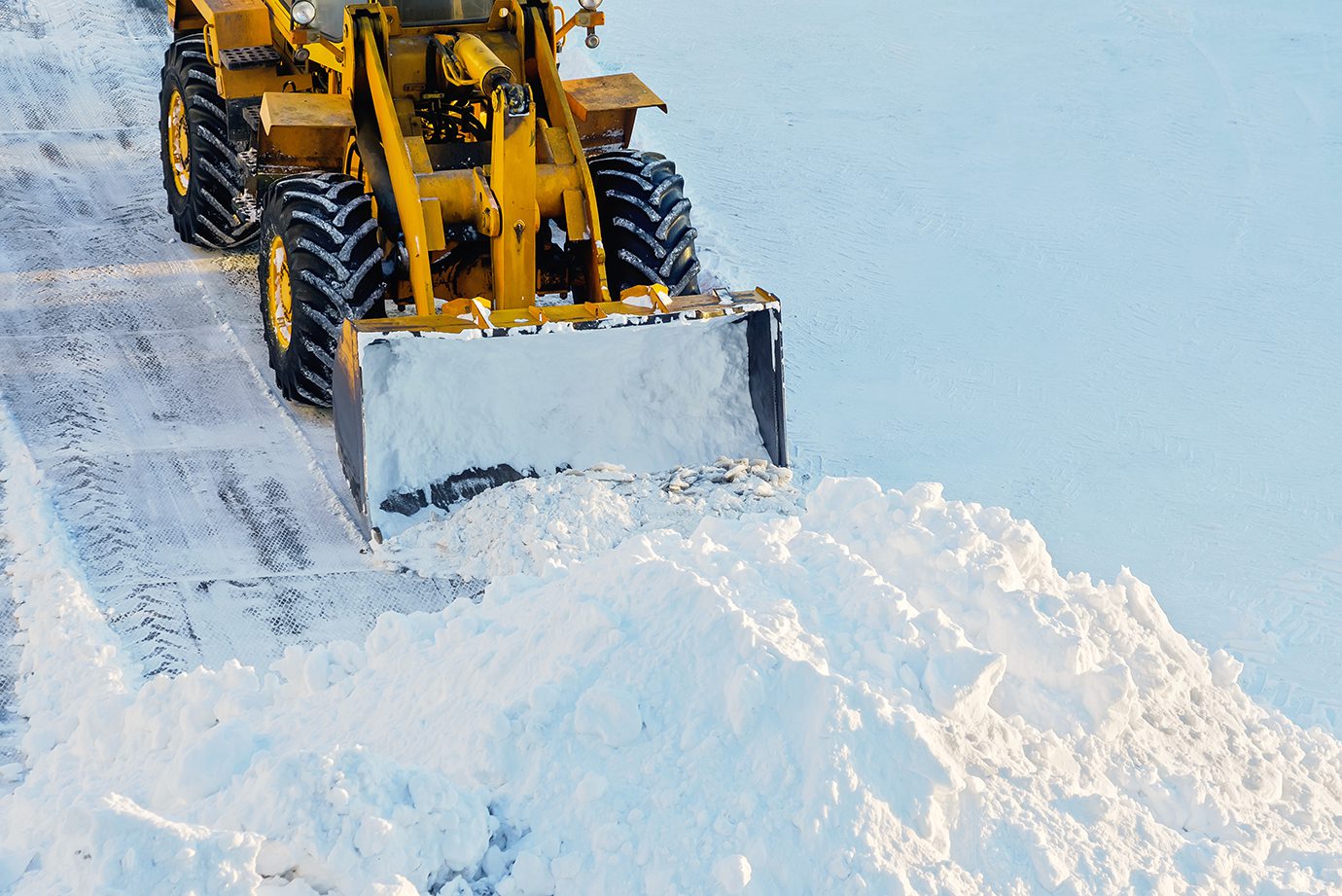 Snow clearing. Tractor clears the way after heavy snowfall.